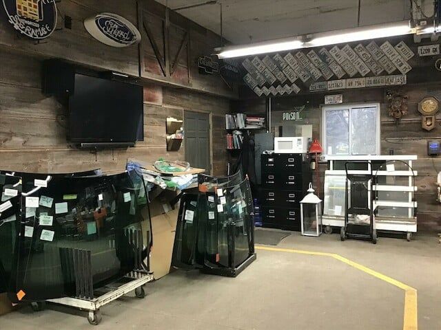 A garage filled with lots of glass and a flat screen tv.