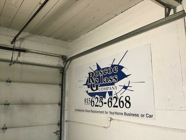 A garage door with a sign that says rescue glass company