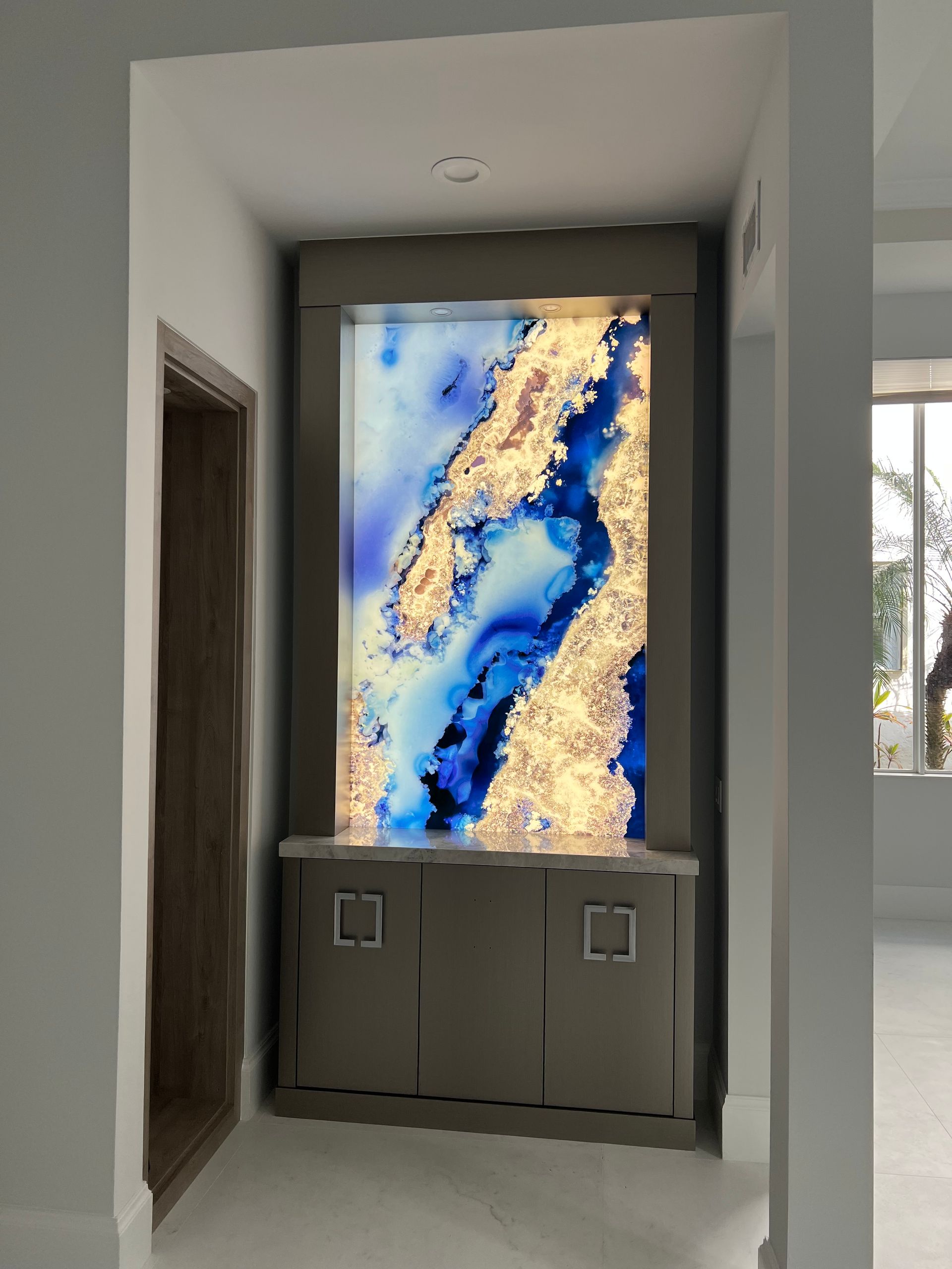 A picture of a blue and gold painting on a wall