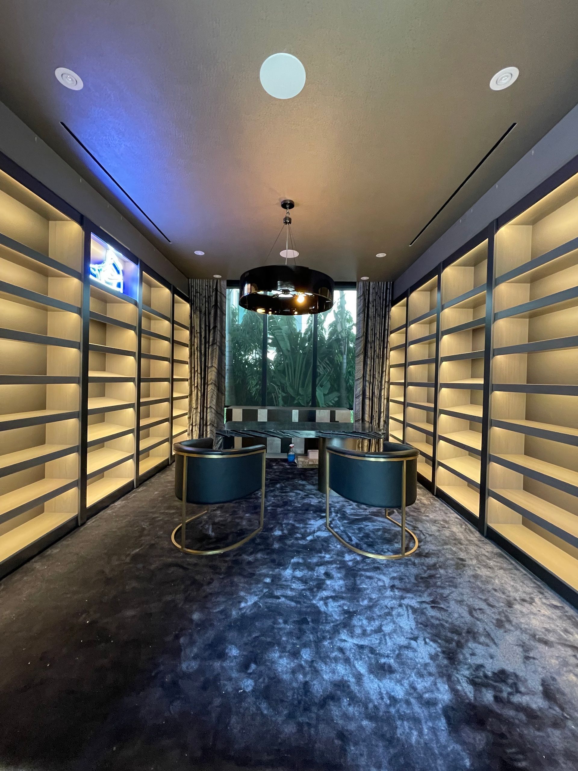 A room with a lot of shelves and chairs