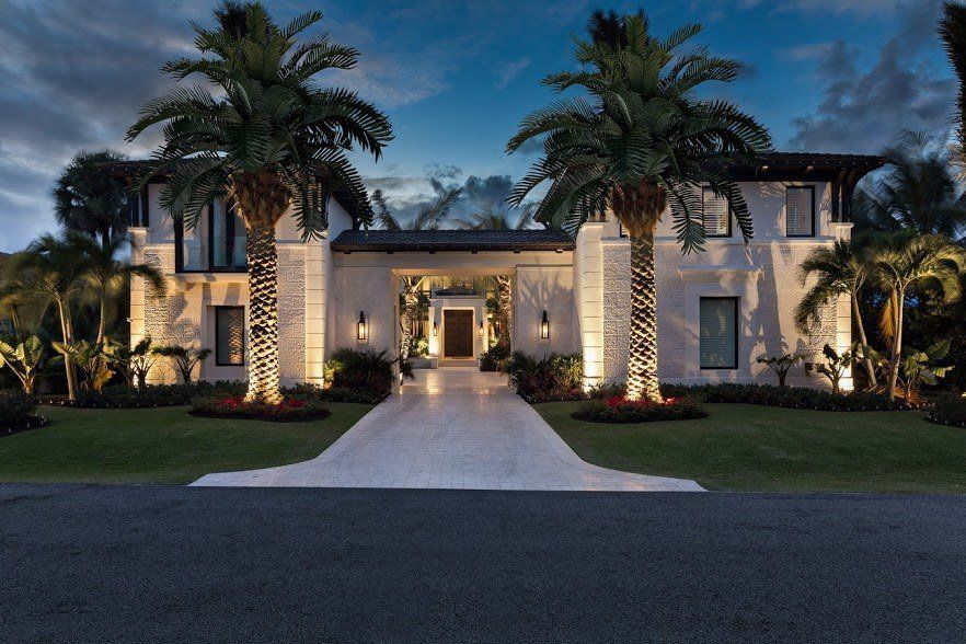 A large house with palm trees in front of it