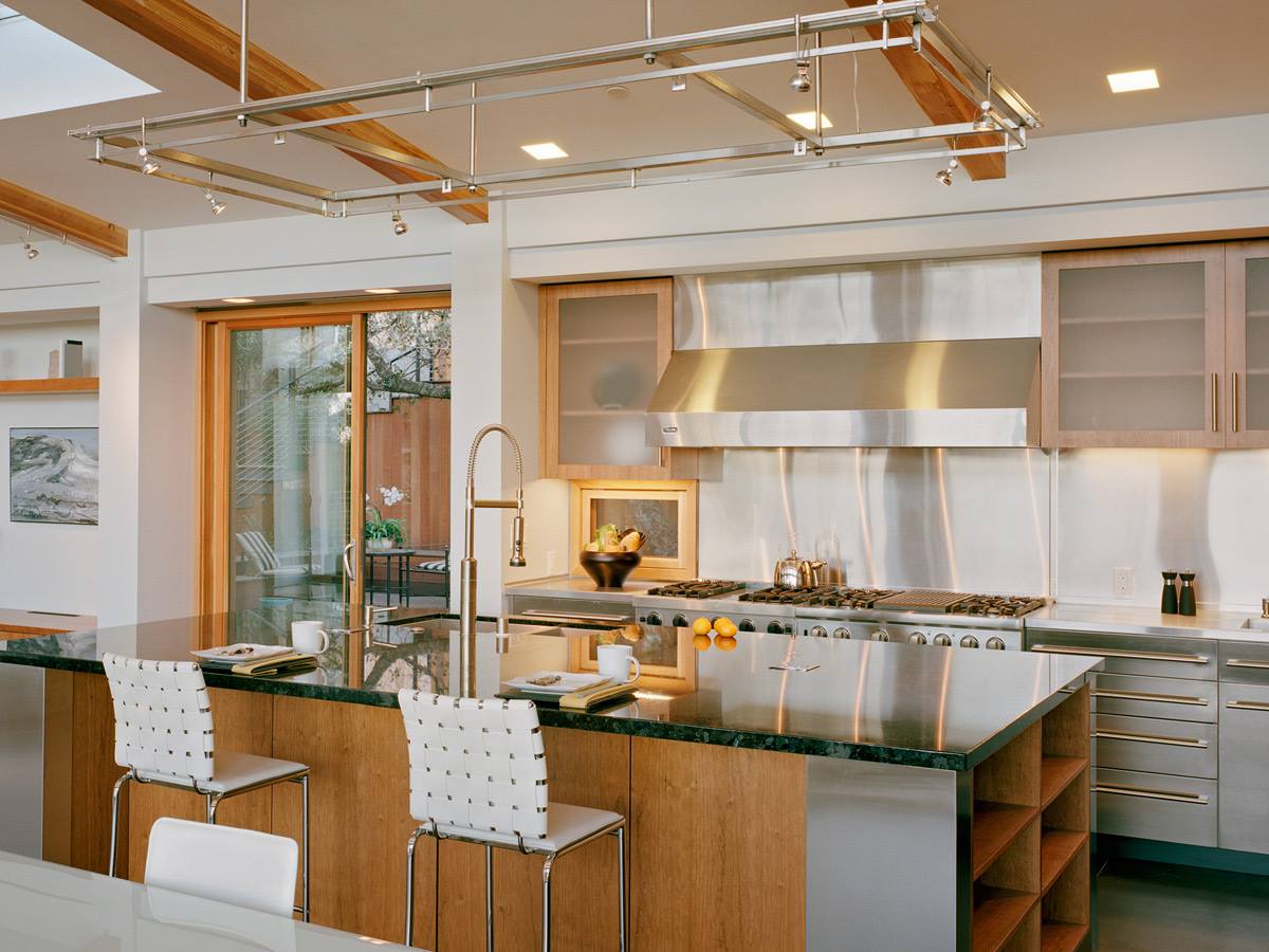 A kitchen with stainless steel appliances and wooden cabinets