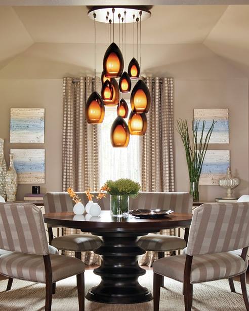 A dining room with a round table and chairs