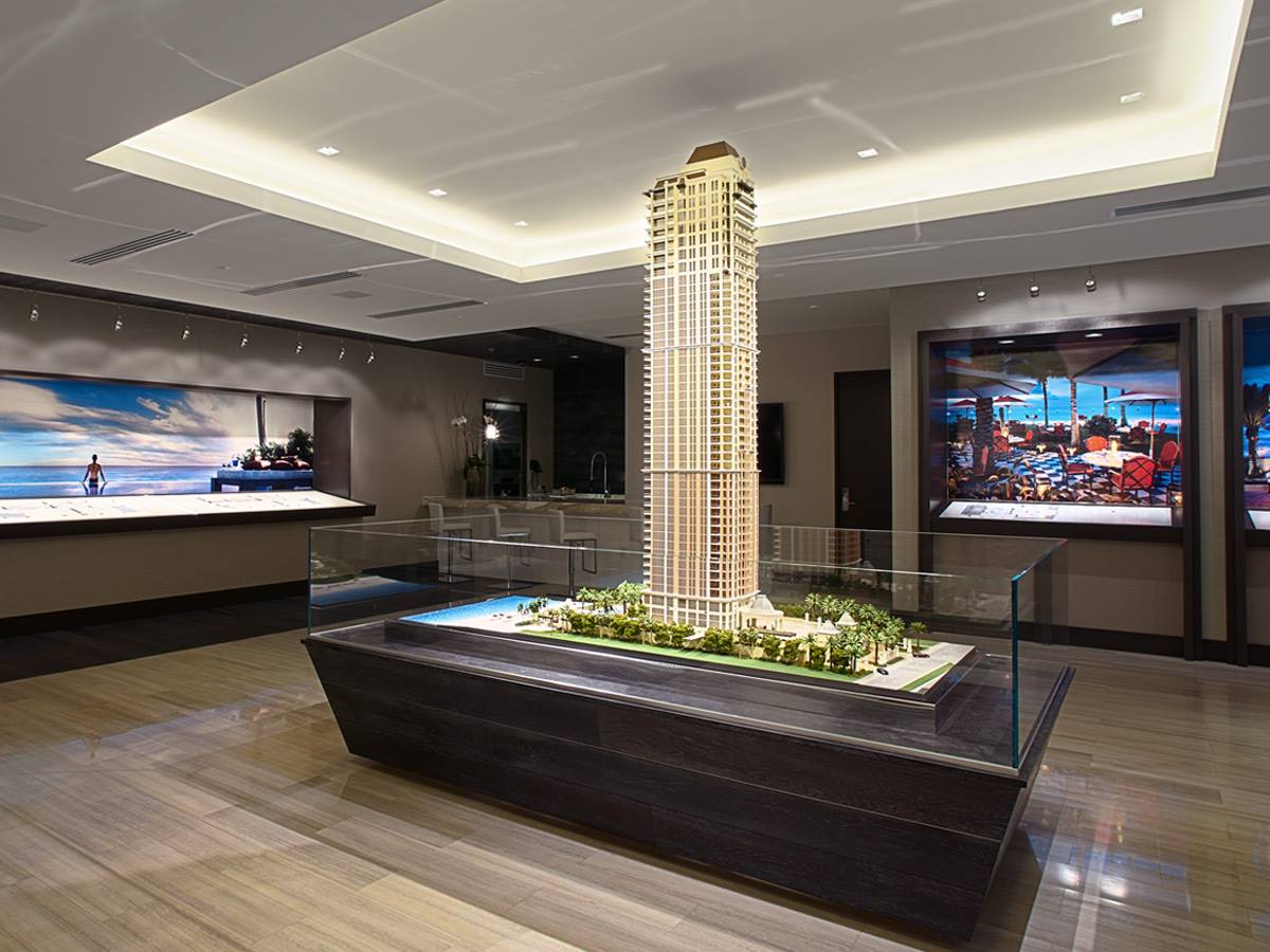 A model of a building is on display in a room