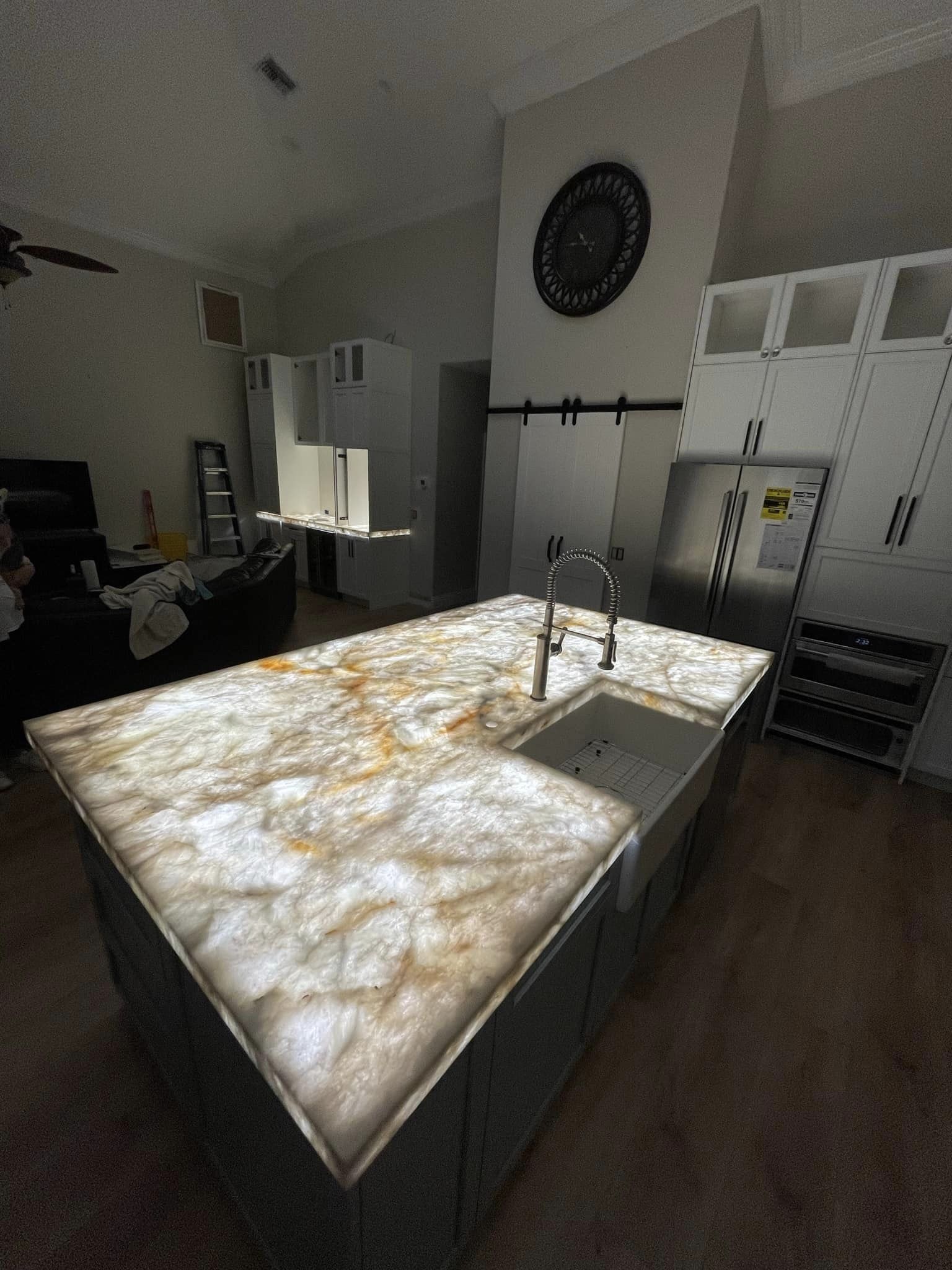 A kitchen with a large island and a sink.