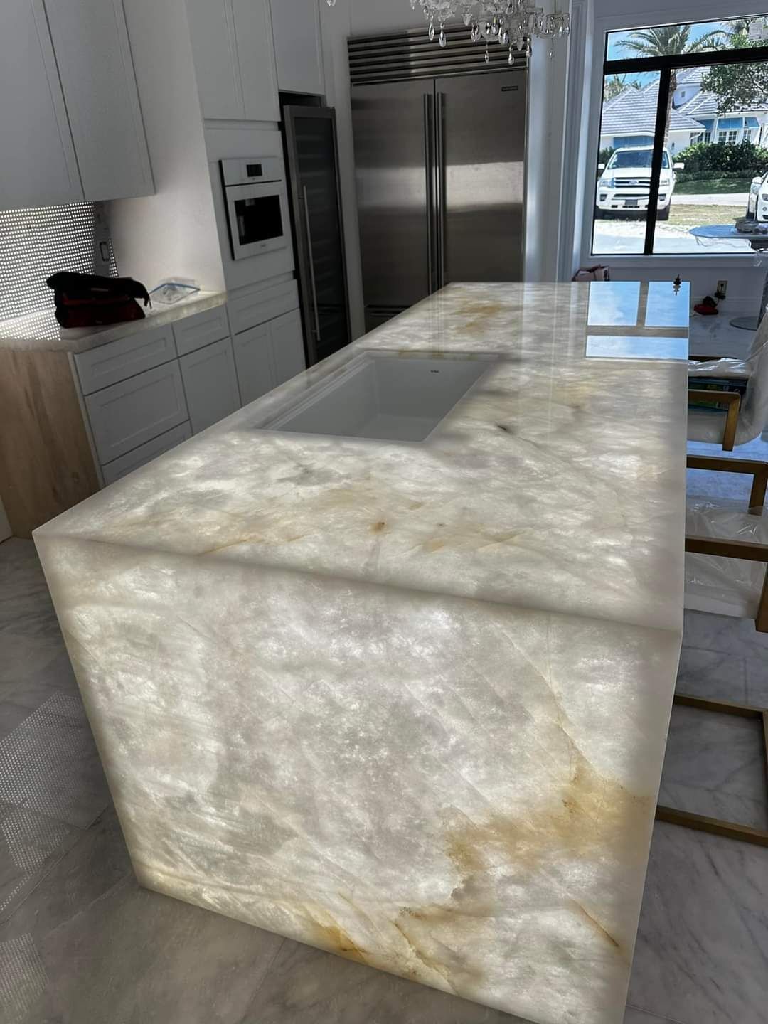 A kitchen with a large island and a sink.