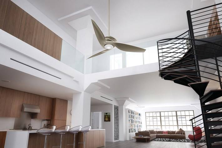 A living room with a spiral staircase and a ceiling fan