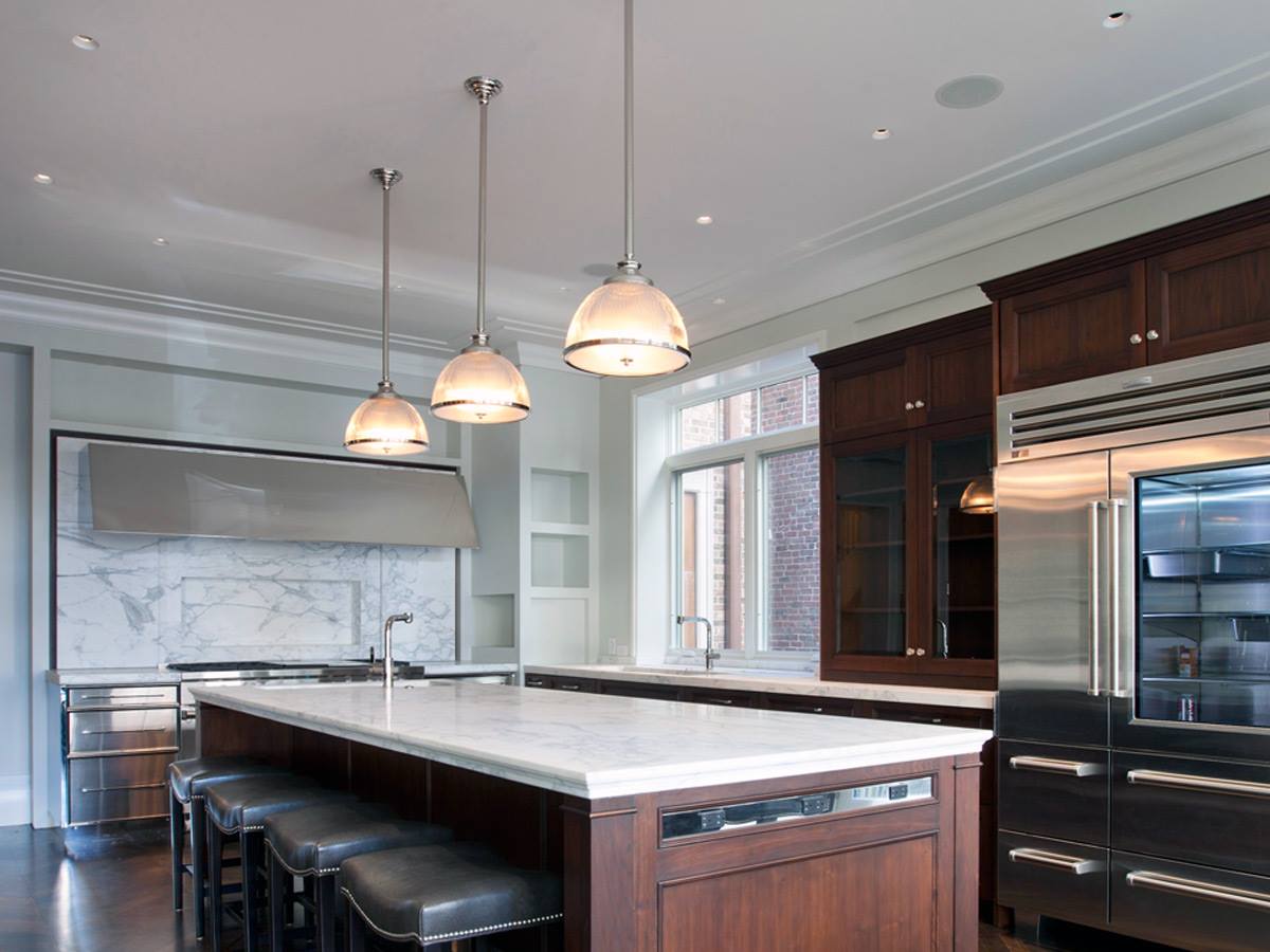 A kitchen with stainless steel appliances and a large island