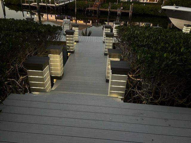 Stairs leading up to a dock with a boat in the background