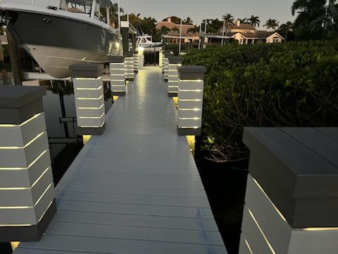 A boat is docked at the end of a dock