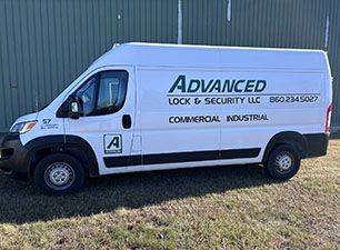 Learn More About Safe Experts White van with Advanced Lock & Security logo parked on grass.