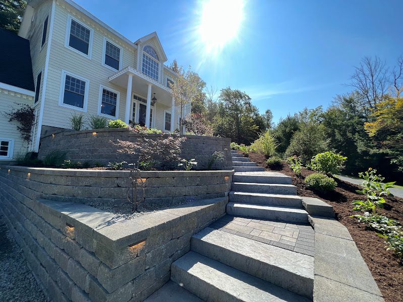 A large white house with stairs leading up to it.