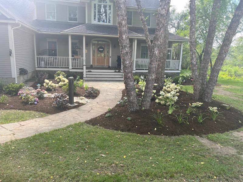 A large house with a porch and a walkway in front of it.