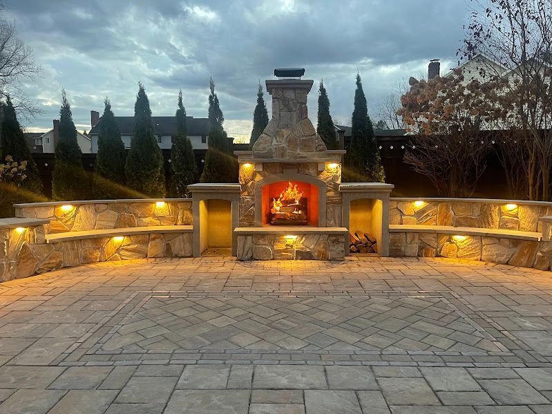There is a fireplace in the middle of the patio.