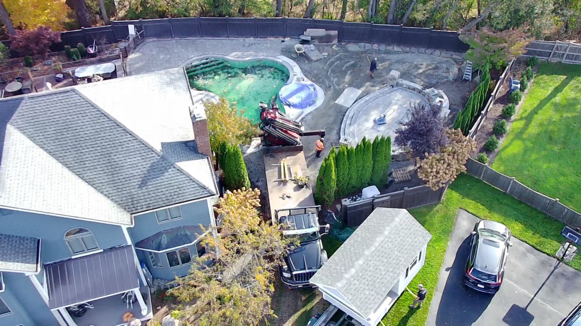 An aerial view of a house with a pool in the backyard.