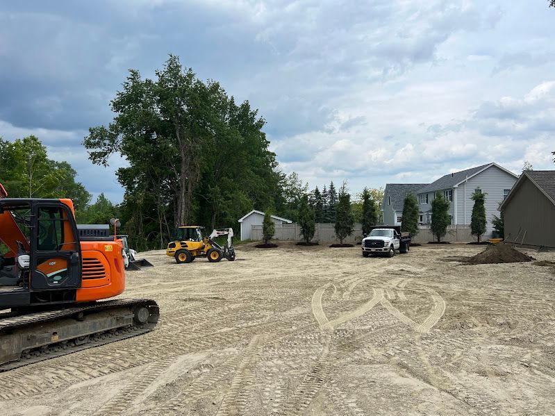 A construction site with a lot of trucks and a bulldozer.
