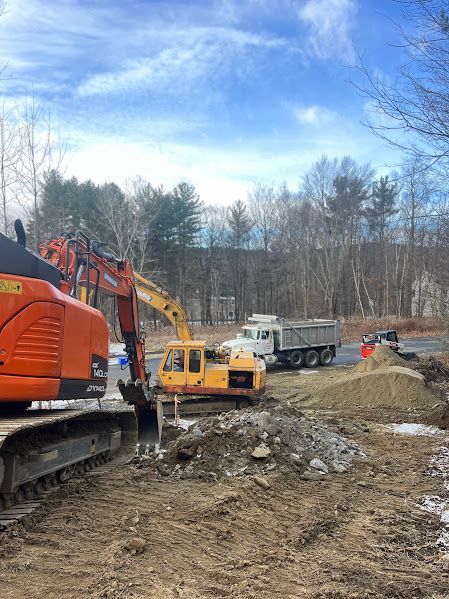 A construction site with a dump truck and a bulldozer.