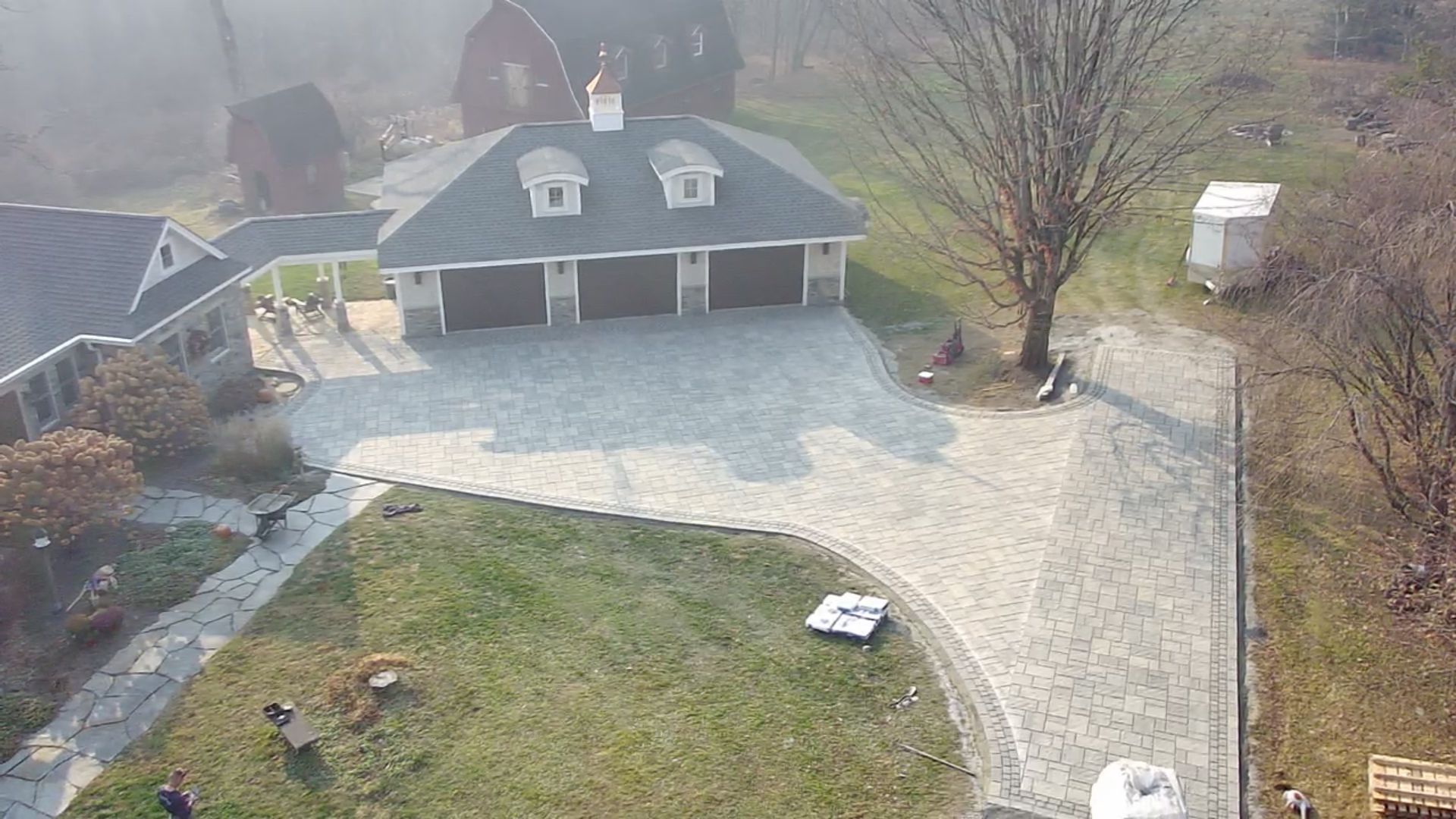 An aerial view of a large house with a large driveway.
