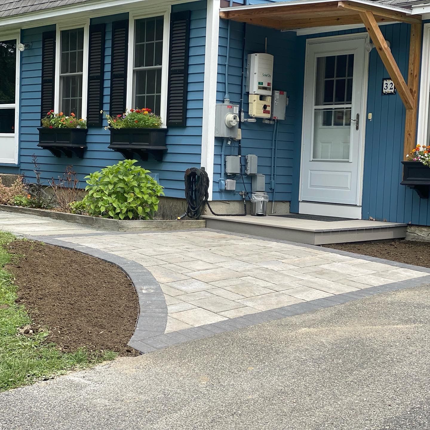 A blue house with a walkway leading to it