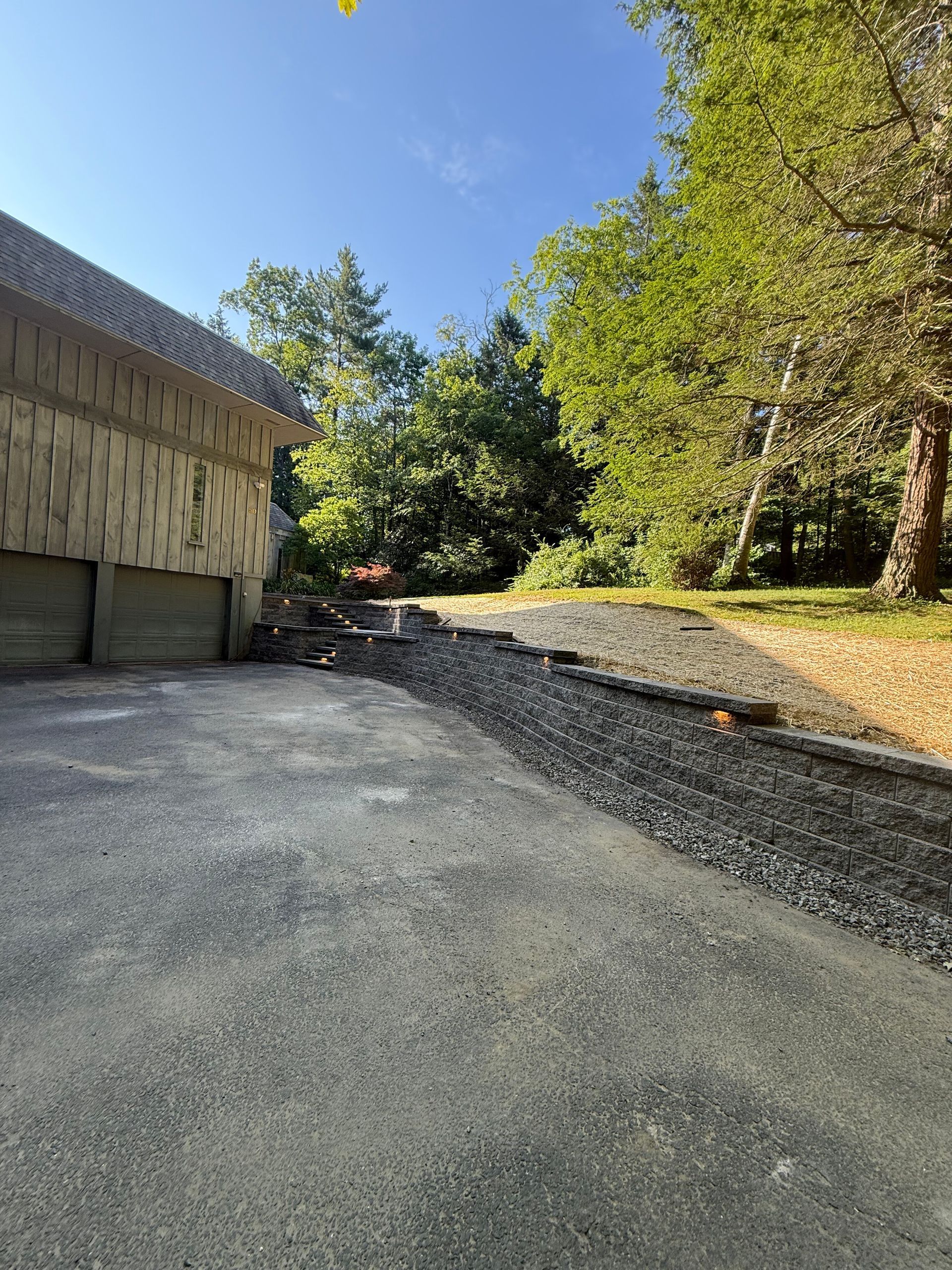 There is a large swimming pool in the backyard of a house.