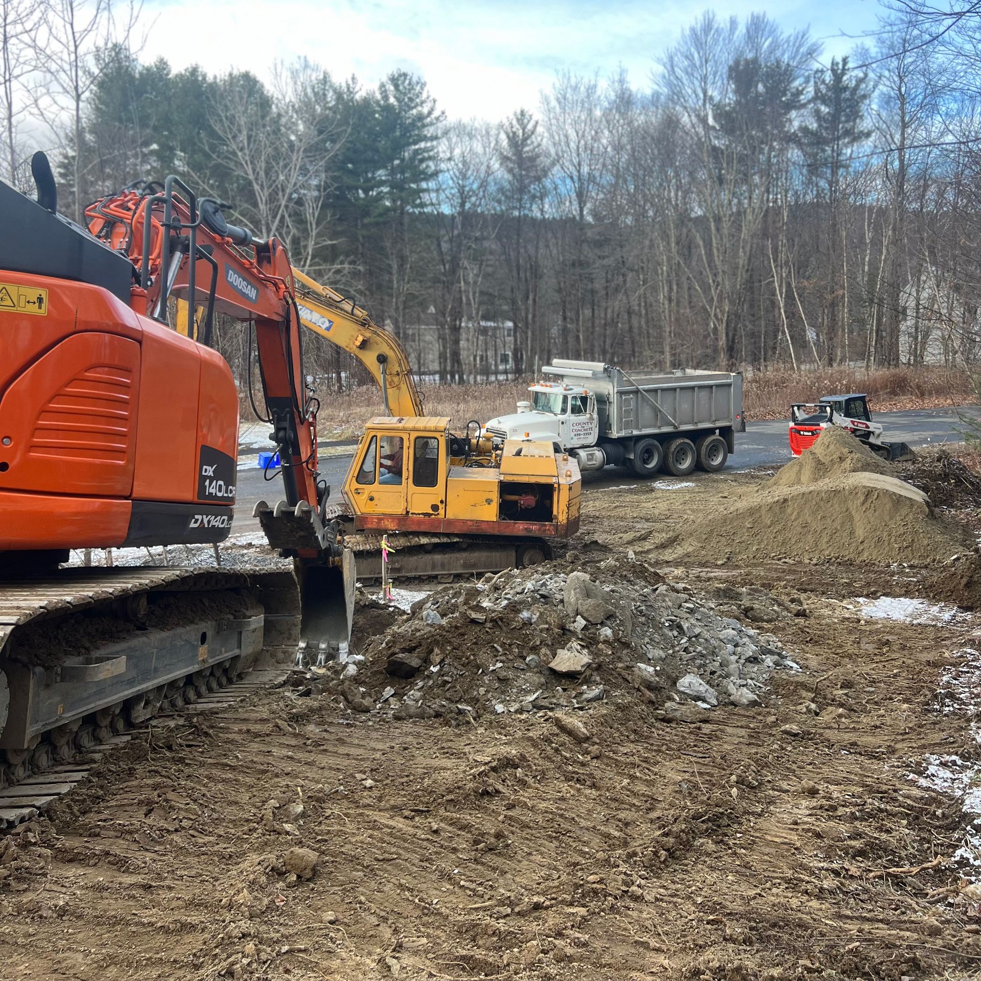 A construction site with a bulldozer and a dump truck.