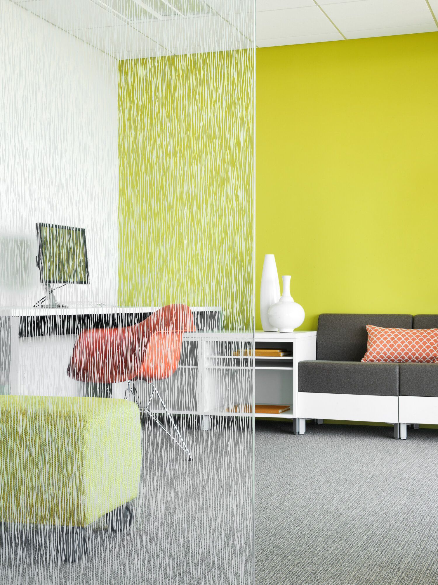 A living room with a couch and a desk