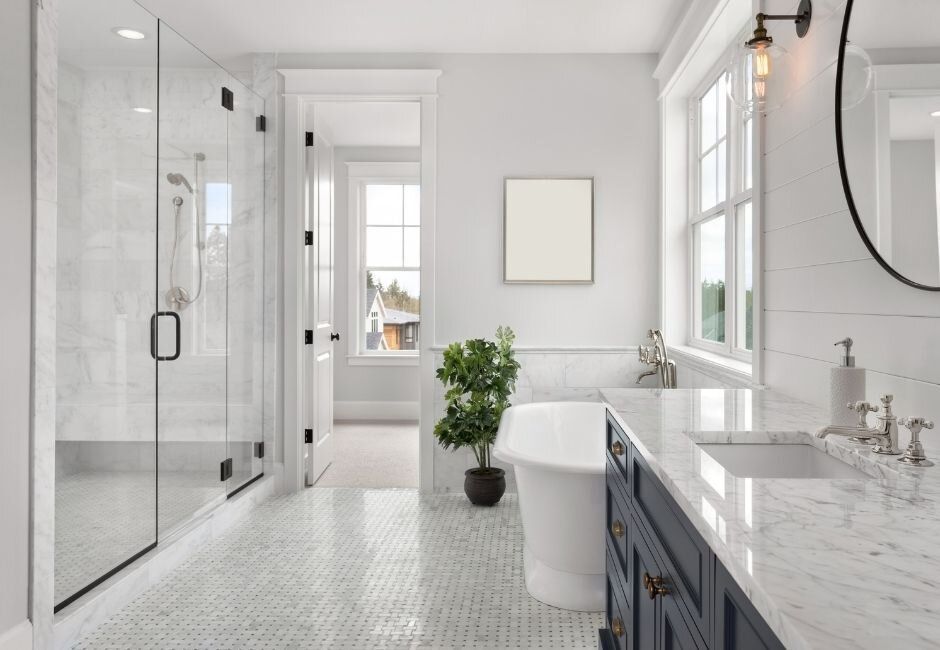 A bathroom with a tub , sink , and shower.