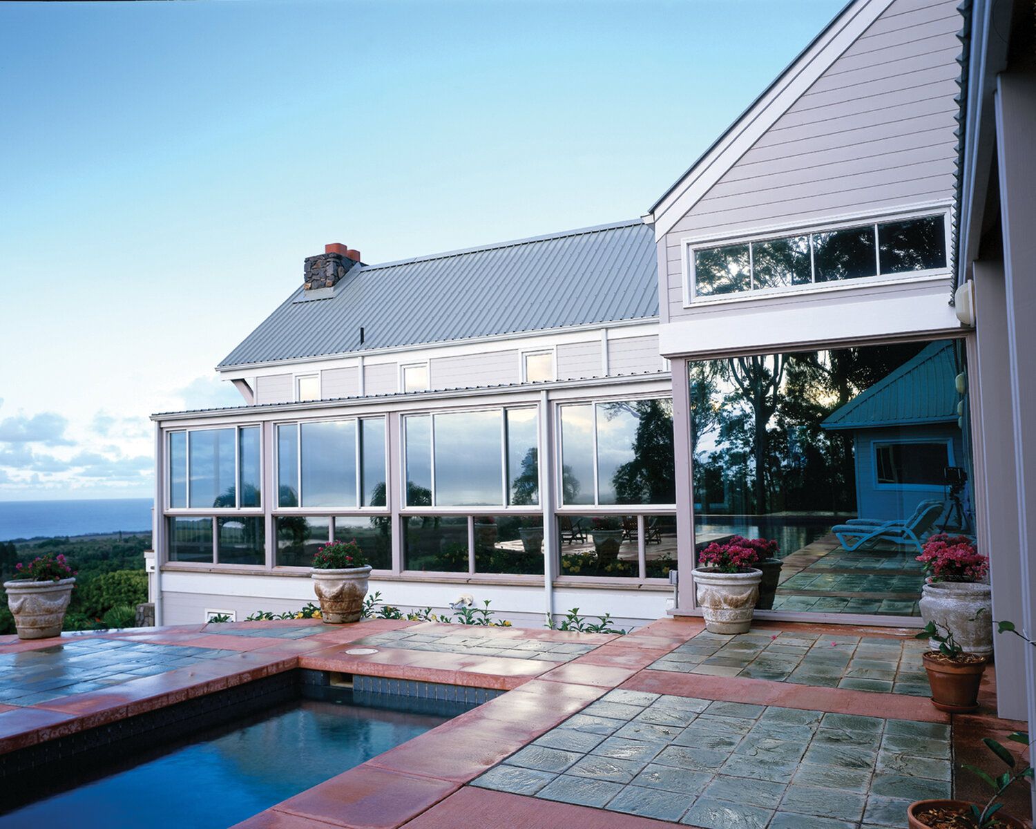A large house with a swimming pool in front of it