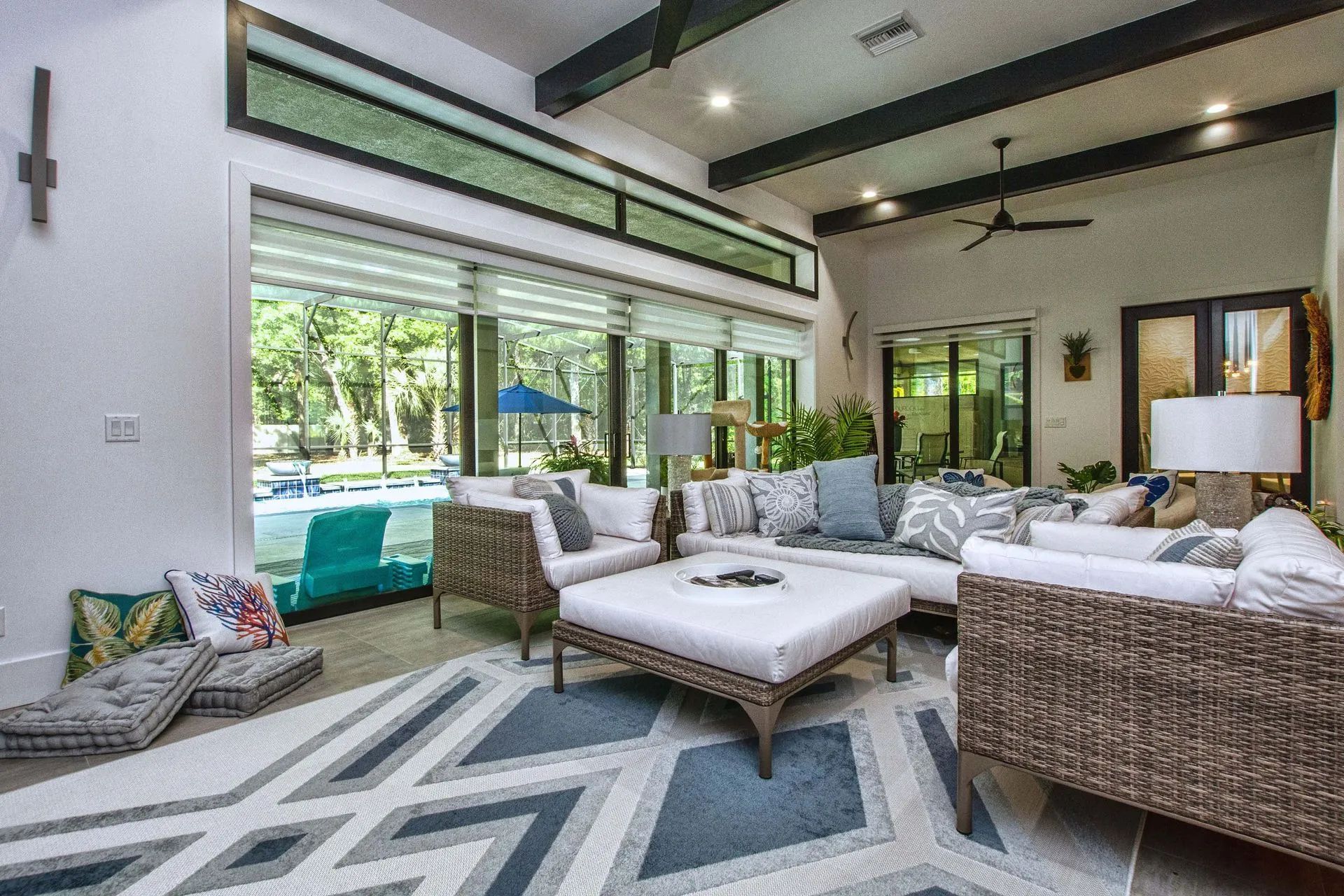 A living room filled with furniture and a rug.