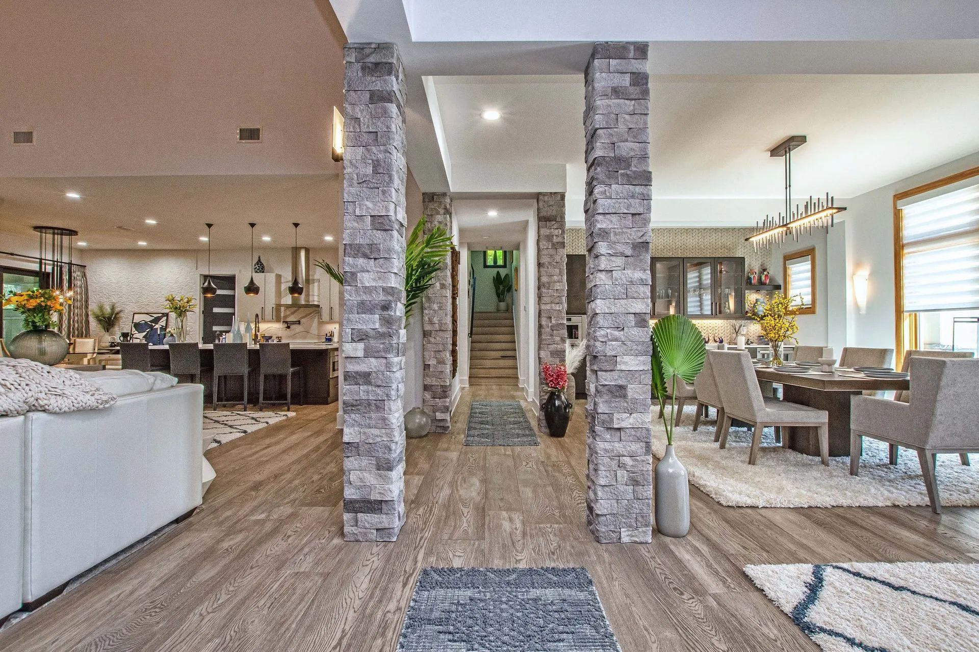 A living room , dining room , and kitchen in a large house.