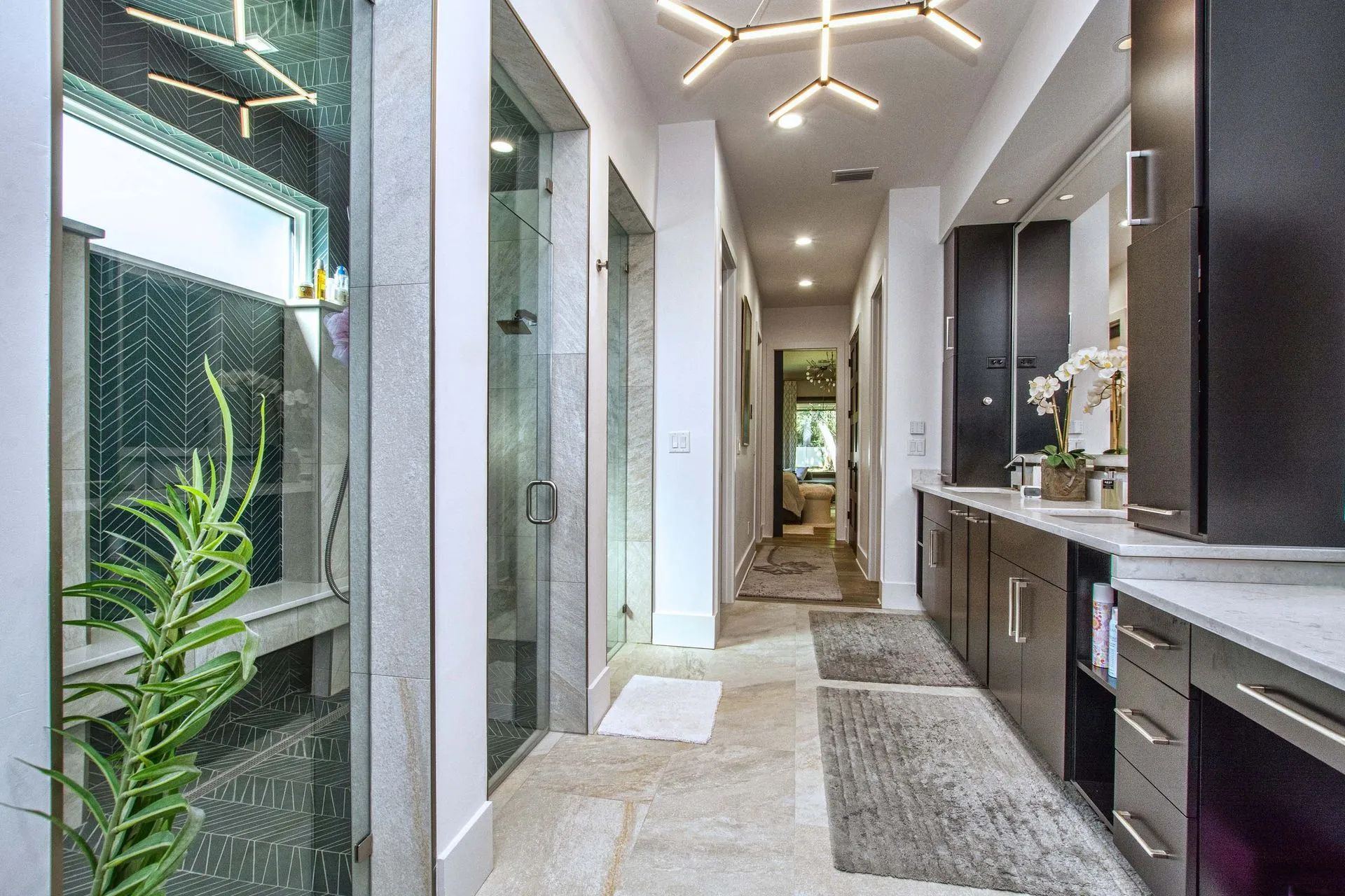 A long hallway leading to a bathroom in a house