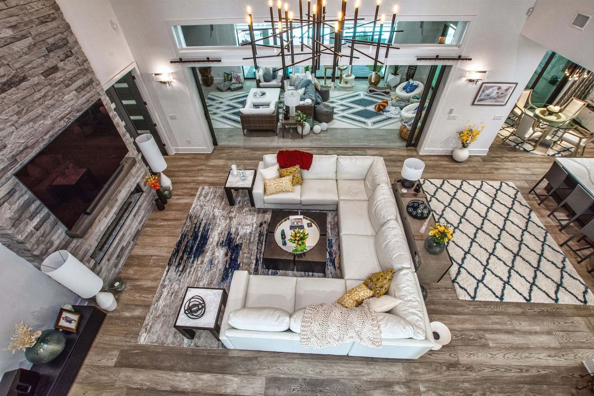 An aerial view of a living room with a large sectional couch and a fireplace.