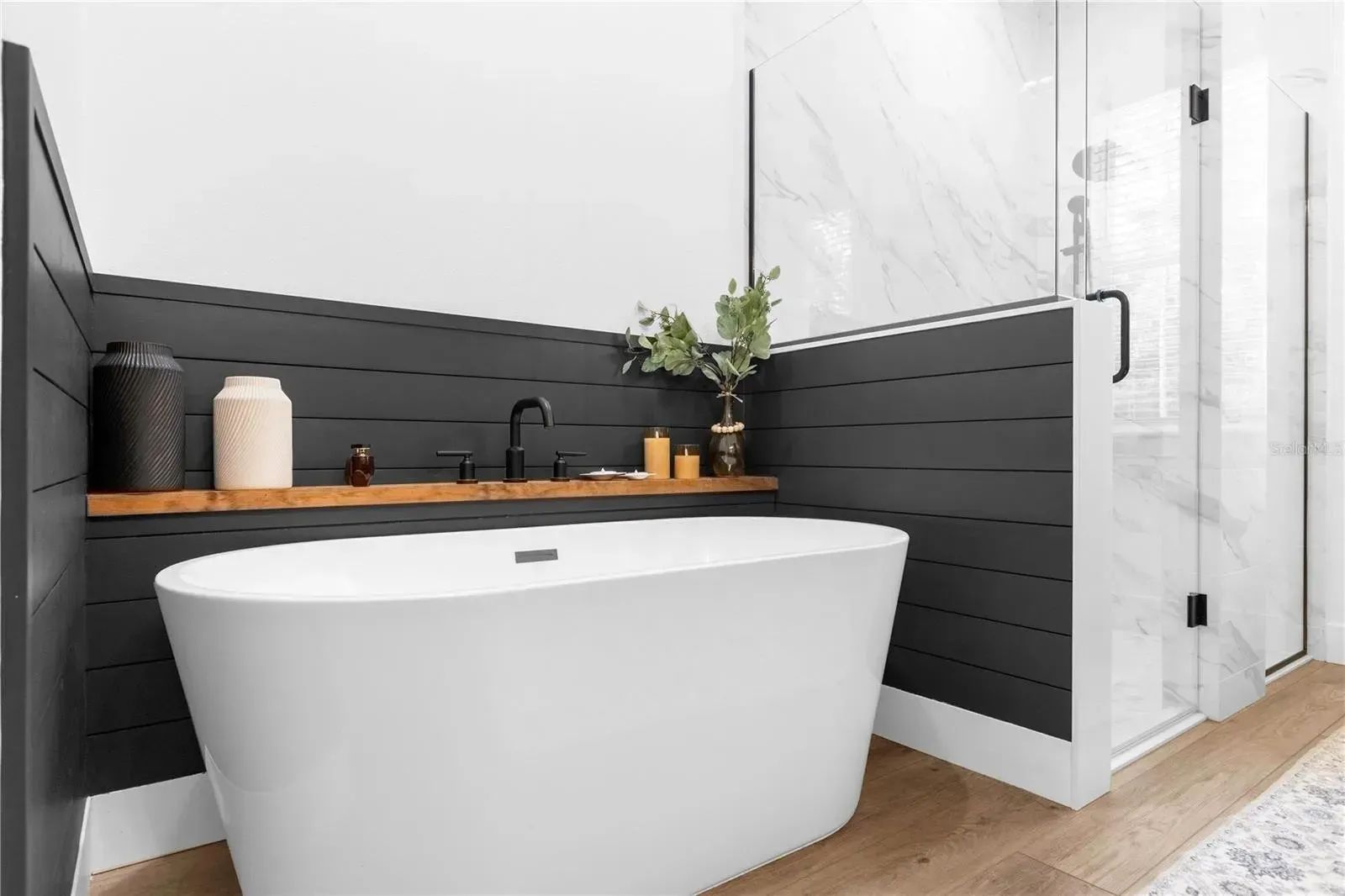 A bathroom with a bathtub and a shower.