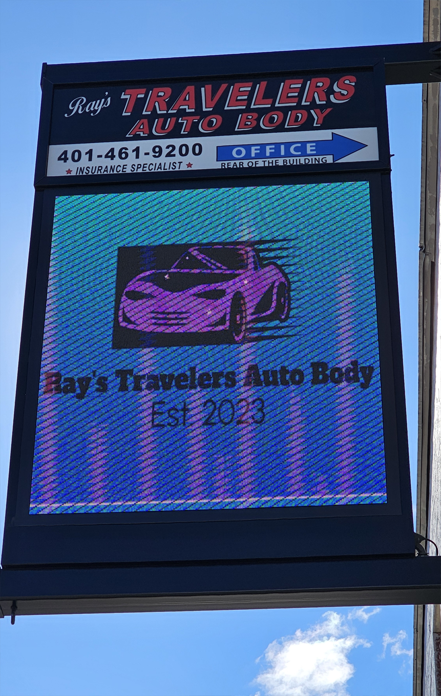A digital LED sign for Ray's Travelers Auto Body.