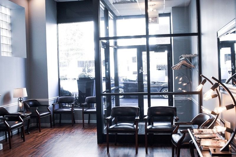 A waiting room with a lot of chairs and lamps