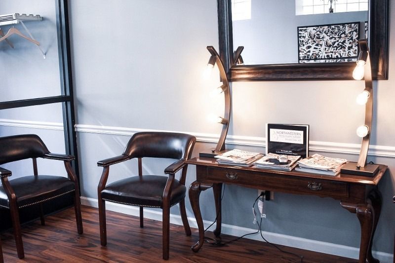 A waiting room with two chairs and a mirror