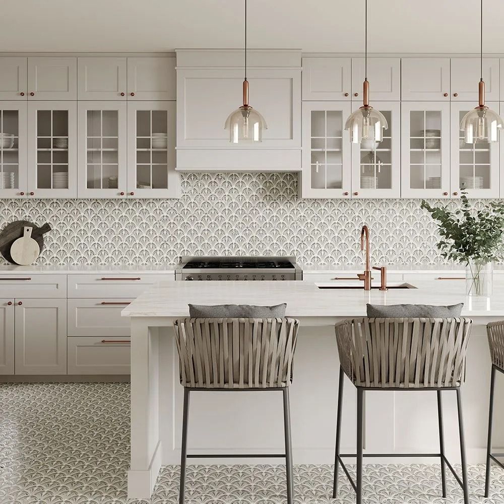 A kitchen with white cabinets and stools and a large island.
