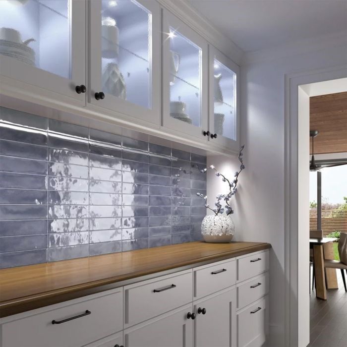 A bathroom with a walk in shower and a window.