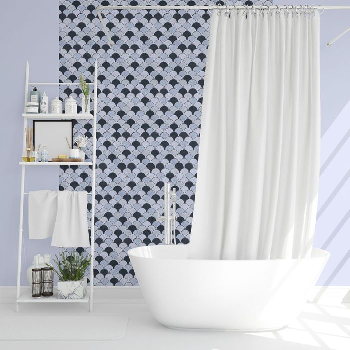 A bathroom with a bathtub and a shower curtain.