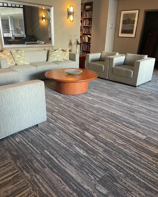 A living room with a couch , chairs , and a coffee table.