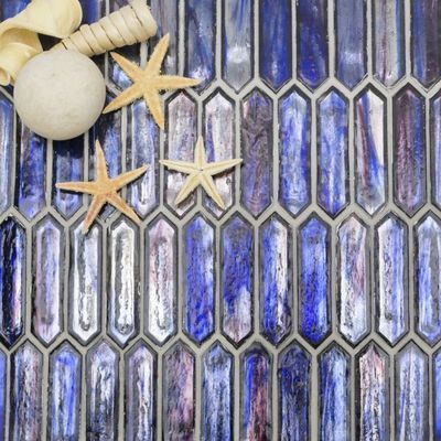 A blue tile with seashells and starfish on it.