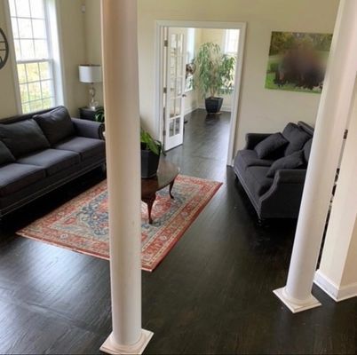A living room with two couches and a rug
