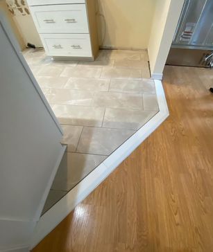 A bathroom with hardwood floors and a white cabinet.