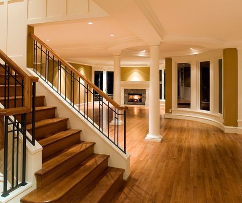 A wooden staircase in a house with a metal railing