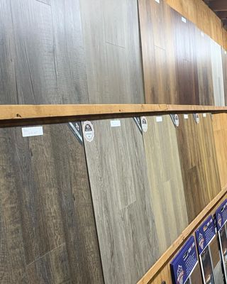 A display of different types of wood flooring in a store.
