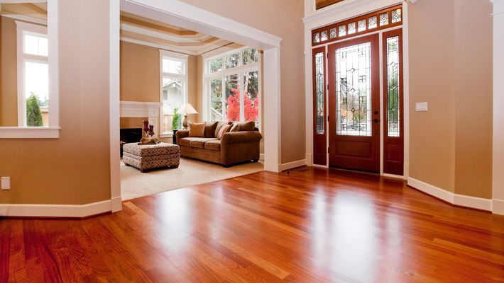 A living room with hardwood floors and a couch.