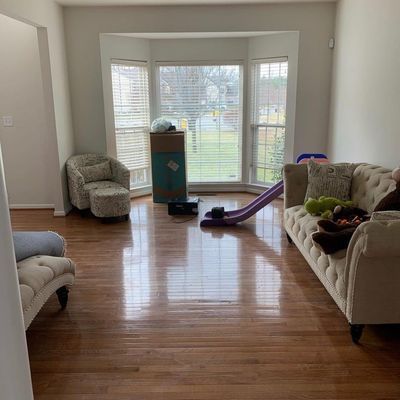 A living room with a couch , chair , and slide.