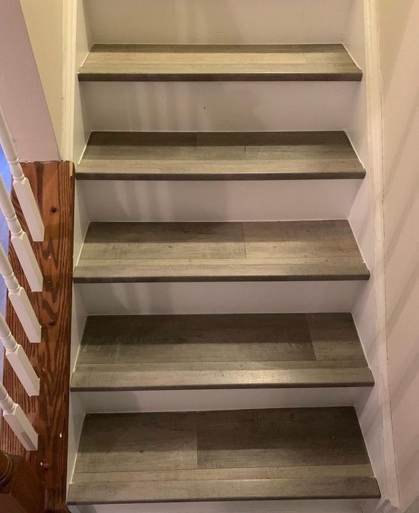 A set of stairs with wooden steps and a wooden railing.