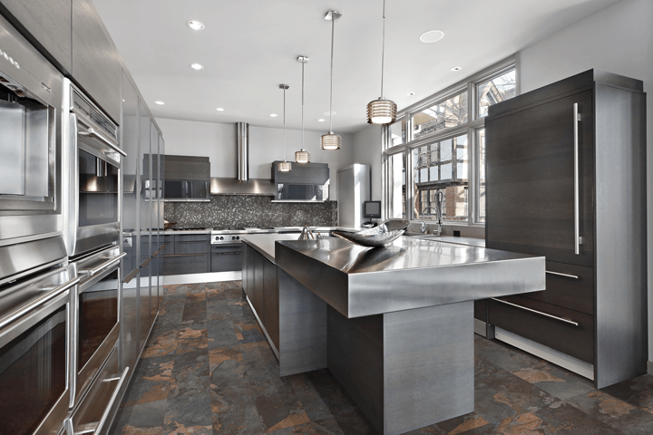 A kitchen with stainless steel appliances and a large island.
