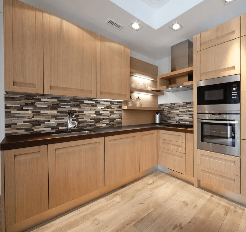 A kitchen with wooden cabinets and stainless steel appliances